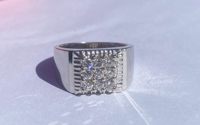A diamond set dress ring, set with a panel of nine diamonds ...