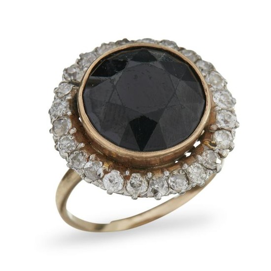 A fourteen karat gold, onyx, and diamond ring