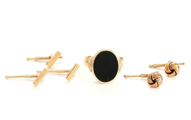 SOLD. A gentleman's ring set with polished onyx, mounted in 14k gold, three 14k gold...
