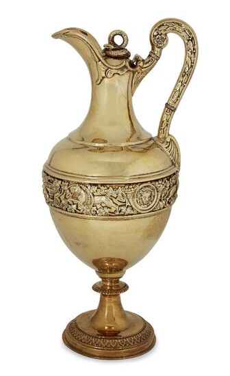 A gilded Victorian silver claret jug by Stephen Smith, London, c.1881, the bulbous body with a band of chased lions, vines and putti raised on a circular stepped foot, the high handle decorated with leaves and beads curving to a hinged lid with...