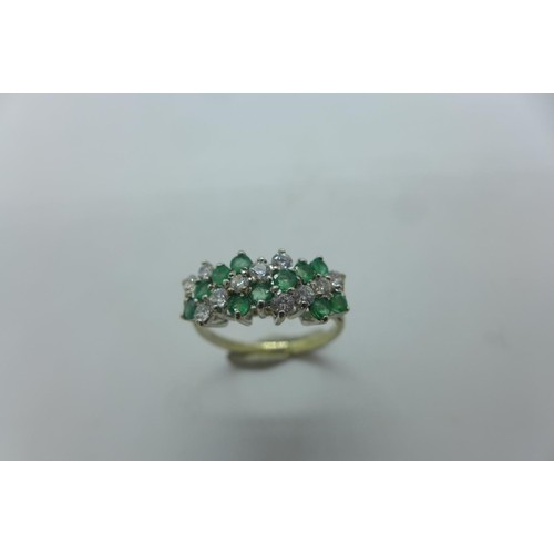 A hallmarked 9ct white gold diamond and emerald ring, size N...