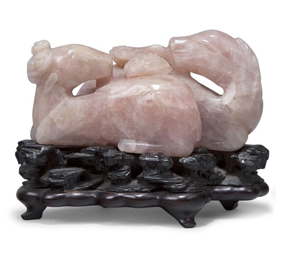 A large Chinese carved rose quartz celestial rams group, 18th/19th century, each carved in recumbent pose, one clutching a lingzhi sprig in its mouth, 12cm long, on fitted hardwood stand Provenance: From the collection of an important Greek...