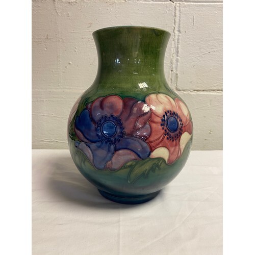A large Moorcroft vase, decorated with anemones on a shaded ...