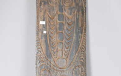 A large Papua New Guinea carved wooden panel, decorated with a vertical band of masks, height 244cm