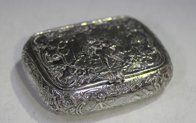 A late 19th century Dutch silver snuff box of curved rectangular form, the hinged lid decorated in r