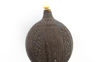 A late 19th / early 20thC carved coconut snuff bottle / flask with banded floral and foliate detail.