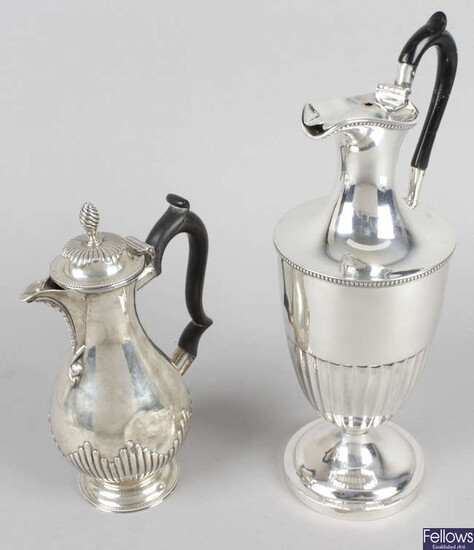 A late Victorian silver lidded jug or ewer & a small hot water pot. (2).