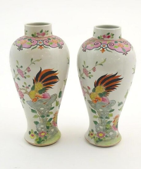 A pair of Chinese famille rose baluster vases decorated