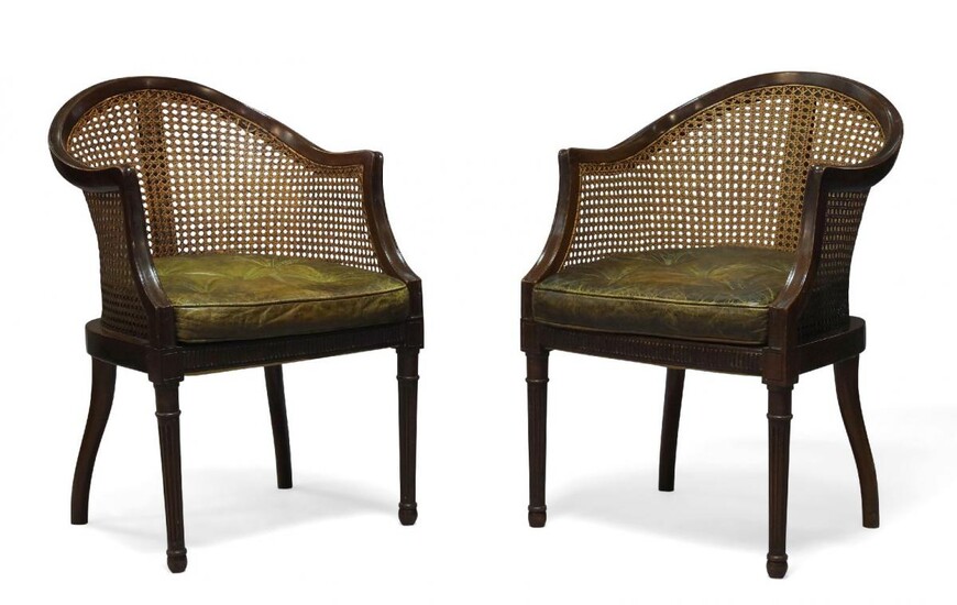 A pair of Regency style mahogany and caned bergere armchairs,...
