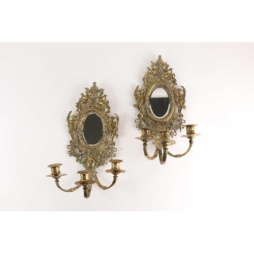 A pair of Victorian cast brass three branch girandoles, the ...