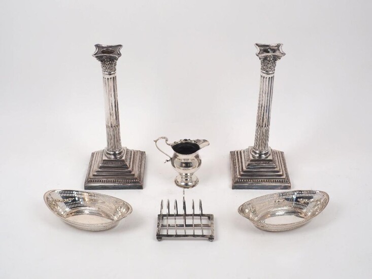 A pair of Victorian silver bonbon dishes, Sheffield, 1897, James Dixon & Sons, of navette form with pierced sides and beaded rims, together with a George V silver cream jug, Birmingham, 1912, Elkington & Co., a silver toast rack by William Hutton &...