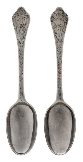 A pair of William & Mary silver dog-nose spoons by Pierre Harache, London, 1699, both later decorated with engraved face to terminals and foliate scroll design to stems, the reverse of terminals later engraved with monogram, 20cm long, approx...