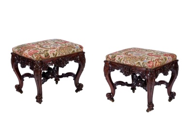 A pair of superb carved mahogany banquettes in the George...