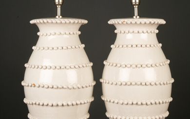 A pair of white glazed pottery lamps