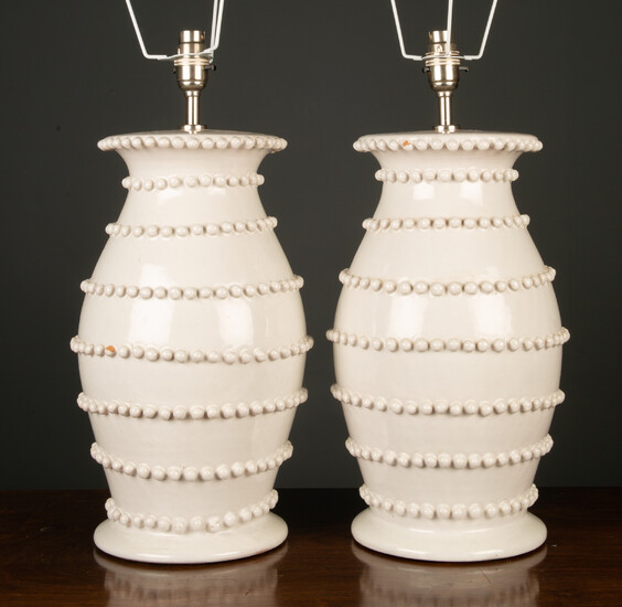A pair of white glazed pottery lamps
