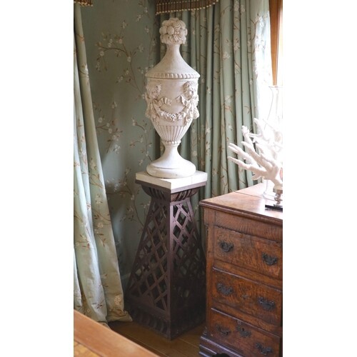 A pair of white painted carved walnut urns and covers, on wr...