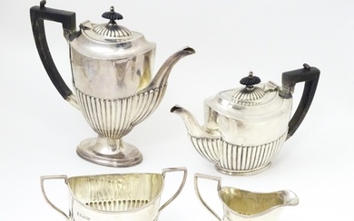 A silver four piece tea set comprising teapot, hot water pot...