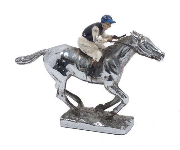 A silver plated model of a racehorse, with enamelled jockey in blue, white and black colours, 10.5cm high, 15.4cm long