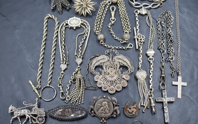 A small selection of white metal jewellery including Albertinas, bracelets and brooches