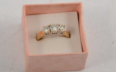 A three stone diamond ring.