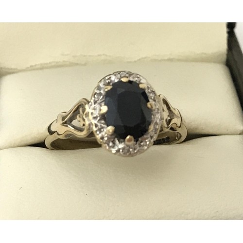 A vintage 9ct gold sapphire and diamond dress ring. Central ...