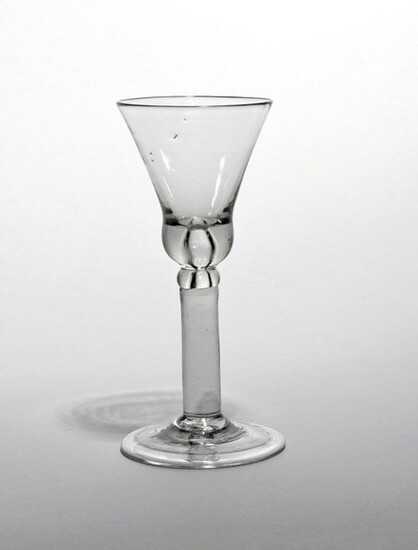A wine glass c.1740, the base of the bell bowl...