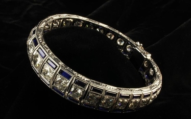 An 18 Carat Gold, Diamond & Synthetic Sapphire Bracelet. Comprising of 29 carre set graduated round