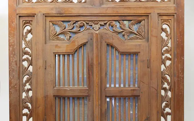 An Indonesian carved teak window shutter converted to a concealed mirror, 20th...