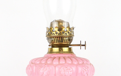 An antique brass oil lamp with pink moulded glass shade,...