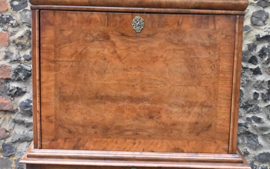 An early 18th century walnut quarter cut secretaire chest...