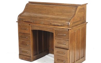 An early 20th century oak roll top desk stamped to lock 'Angus London'.