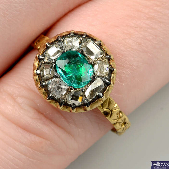 An emerald and vari-cut diamond cluster ring, with floral band.
