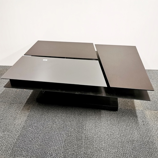 An unusual contemporary designer coffee table in dark cherry and glass with three sections, two adjustable in height and one storage compart