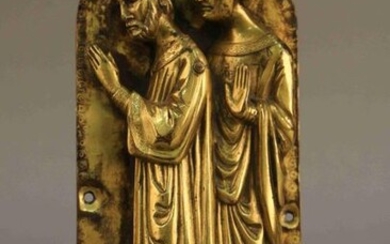 Arched PLATE decorated with two ecclesiastical figures in repoussé gilt bronze. Enamelled eyes. Gothic style. Height : 26,5 cm