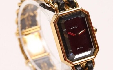 CHANEL, Ladies' watch model "Première" in gilded metal. Black dial D: 20 mm. Bracelet decorated with two black leather links. Quartz movement. Signed and numbered