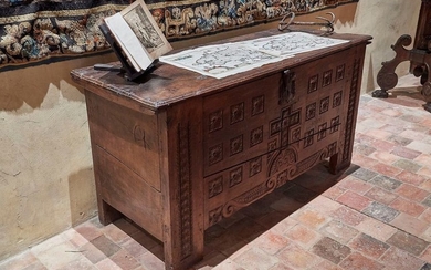 Carved chestnut wood chest with decoration on the...