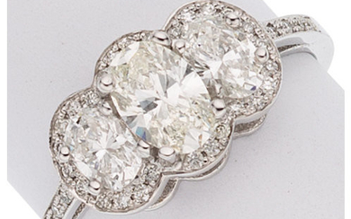Diamond, White Gold Ring The ring centers an oval-shaped...