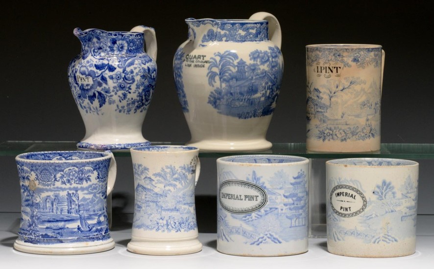 FIVE BLUE PRINTED EARTHENWARE MUGS AND TWO JUGS, SECOND HALF...