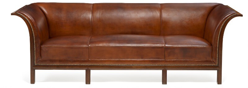 Frits Henningsen: Freestanding three seater sofa with six-legged Cuban mahogany frame. Upholstered with patinated brown leather, fitted with brass nails.