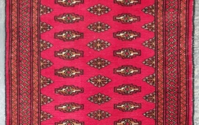Hand Woven Afghan Bokhara Carpet on red ground with patterned border (110 x 79cm)