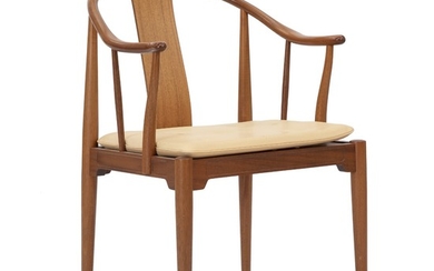 Hans J. Wegner: “China Chair”. Mahogany armchair. Seat cushion upholstered with natural leather. Manufactured and marked by Fritz Hansen.