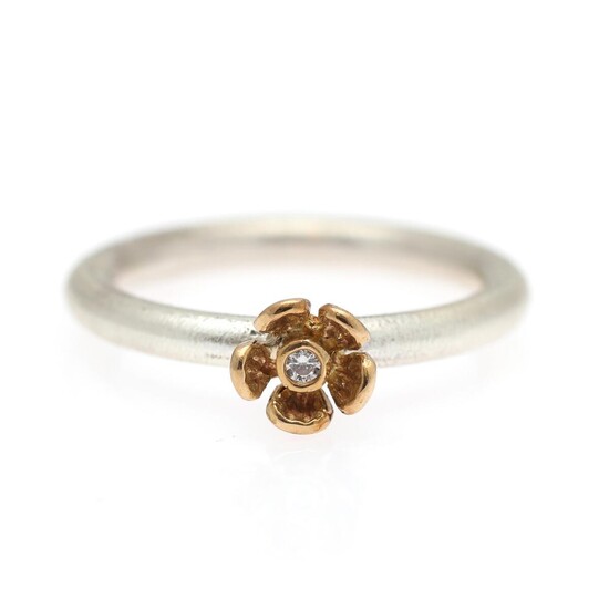 SOLD. Milas: A diamond ring in the shape of a flower set with a diamond weighing app. 0.02 ct., mounted in sterling silver and 18k gold. Size 54. – Bruun Rasmussen Auctioneers of Fine Art