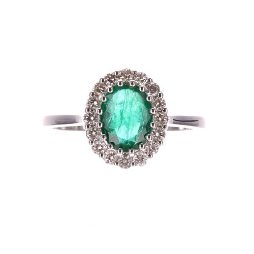 Modern 18ct white gold oval emerald and diamond cluster ring...