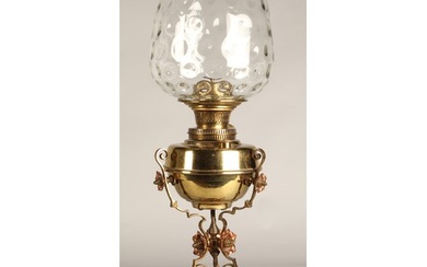 Oil lamp with copper and brass foliate decoration on the bas...