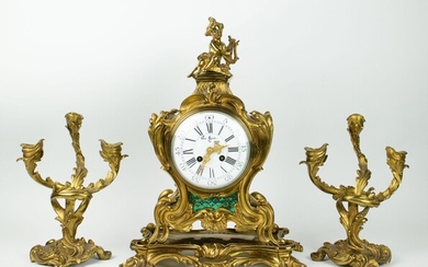 Pendule et 2 chandeliers en bronze doré, signés dans le cadran Van Gent 1855Pendule et...