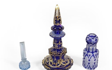Three Glass Scent-Bottles, comprising: a gilt-heightened blue glass example, 19.5cm...