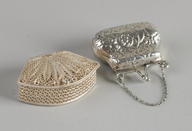 Two silver boxes with one box in the shape of a purse