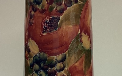 WILLIAM MOORCROFT: A tall "Pomegranate" spill vase on mottled green ground. Made for Liberty & Co.