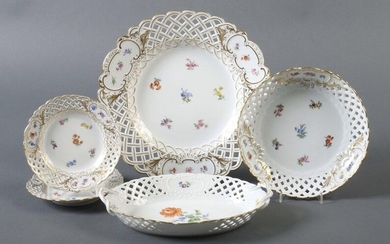 five openwork Meissen, 1924 - after 1934, porcelain, glazed, open worked rims with rocaille cartouches in relief, containing scattered flowers in polychrome on glaze, the mirror showing either scattered flowers or rose with forget-me-not, mostly...