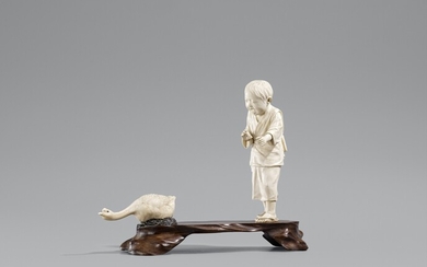 A ivory and wood okimono of a boy and a goose. Around 1900